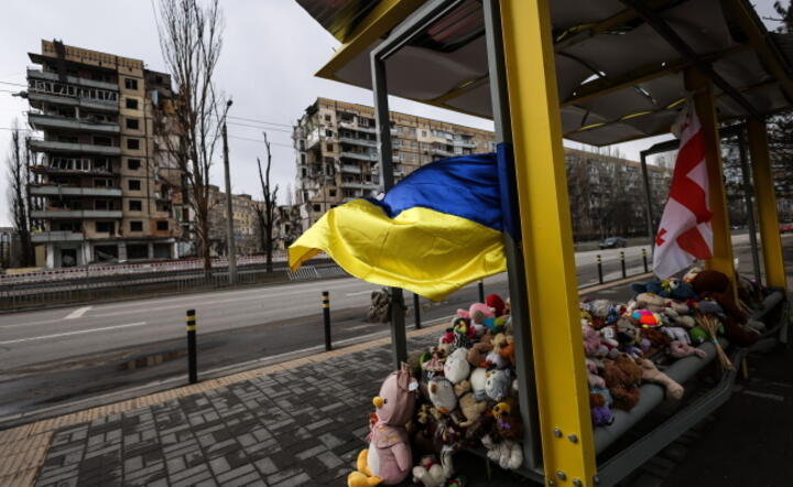 Przystanek autobusowy wypełniony dziecięcymi zabawkami przed zniszczonym rakietą przez Rosjan budynkiem w Dnieprze, gdzie zginęło 46 osób / autor:  PAP/Leszek Szymański